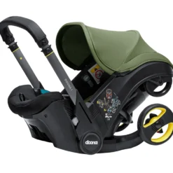 Doona I Babyskydd Och Barnvagn I Ett Desert Green