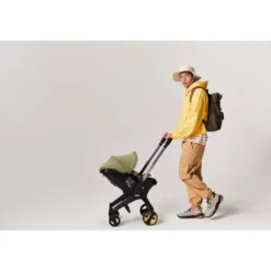 Doona I Babyskydd Och Barnvagn I Ett Desert Green